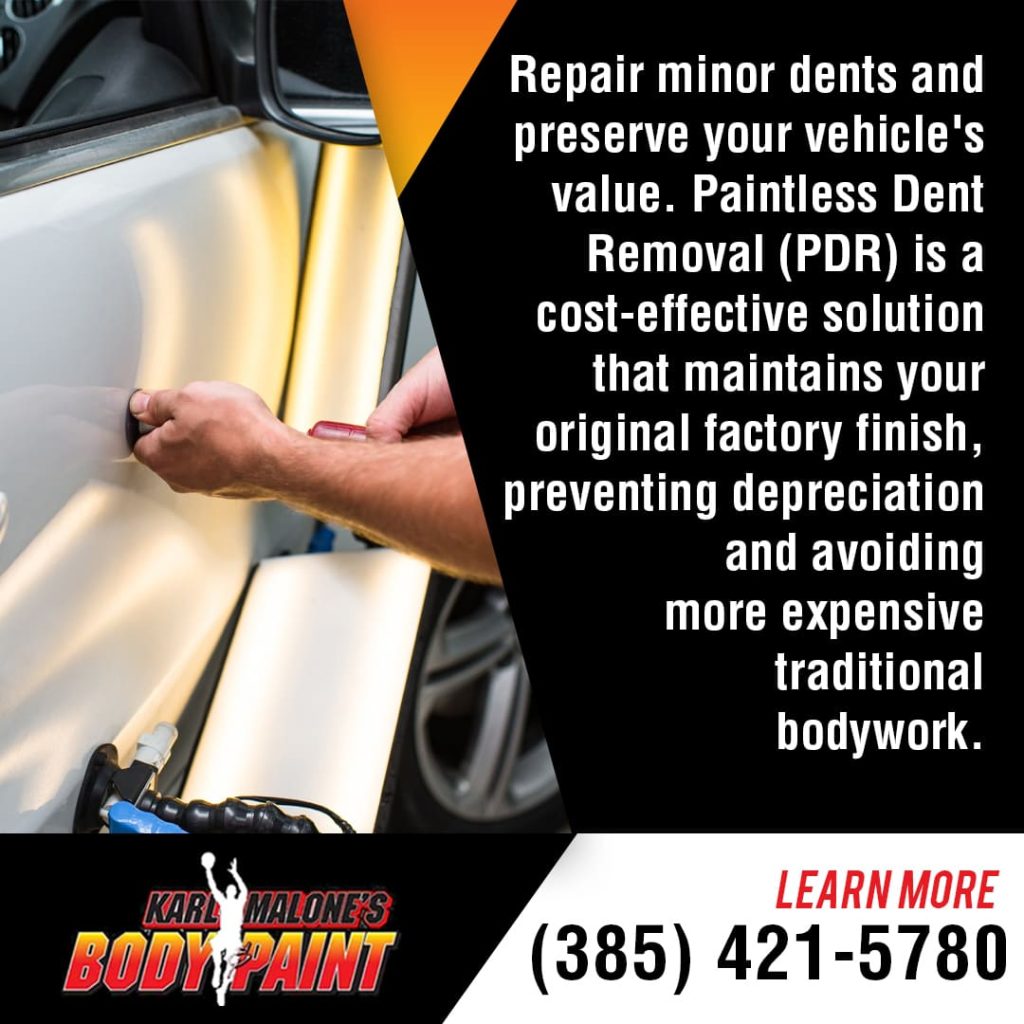 A technician performs paintless dent removal (PDR) on a car door, a cost-effective solution to preserve the vehicle's factory finish.