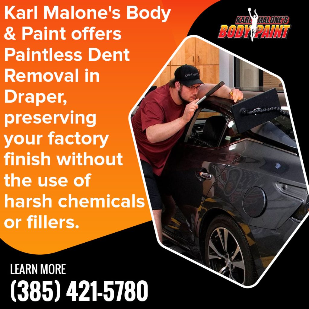 Technician performing paintless dent removal on a vehicle at Karl Malone’s Body & Paint in Draper, Utah