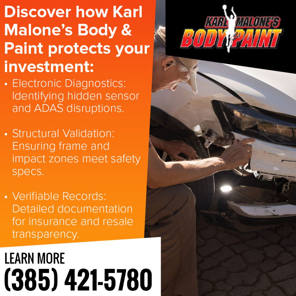 Technician inspecting front-end damage on a white vehicle at Karl Malone’s Body & Paint to verify structural safety and hidden sensor issues